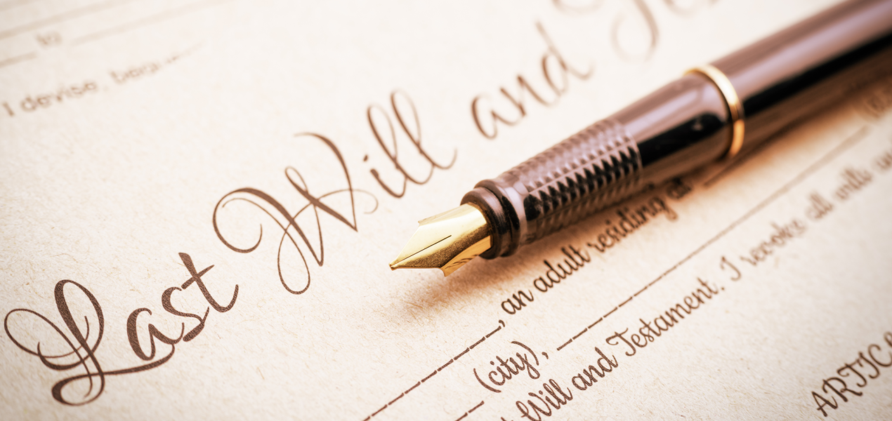 A fountain pen on top of papers titled "Last will and Testament".
