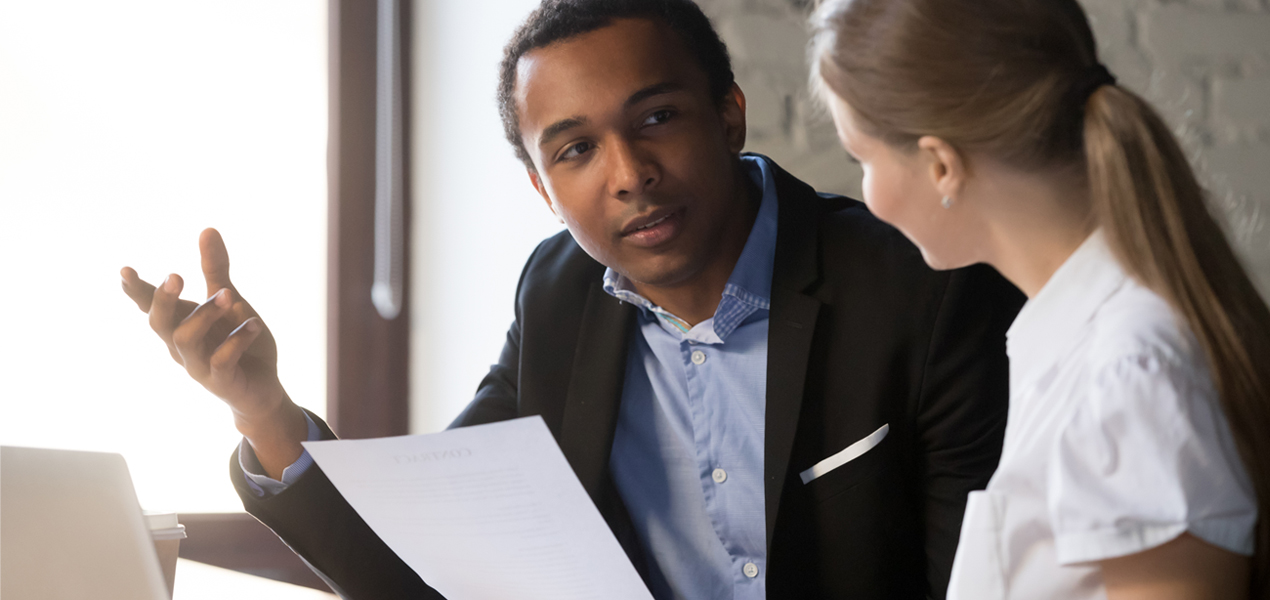 Boss discussing contract details with woman.