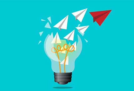 Paper planes flying out of a shattered light bulb, symbolizing creative ideas taking flight